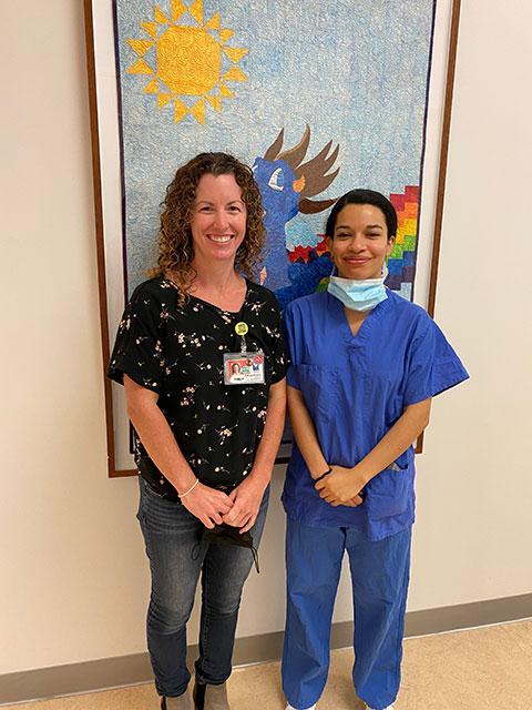 Jennie Link and Kate Ropp standing in front of a painting